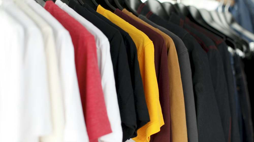 Folded clothing organised by season for under-bed storage