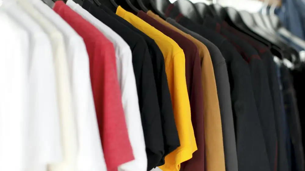 A freestanding rail system holding hanging and folded clothing